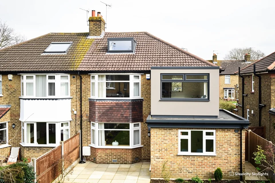 Pair of semis, one with a box dormer loft conversion and roof windows in the tile roof