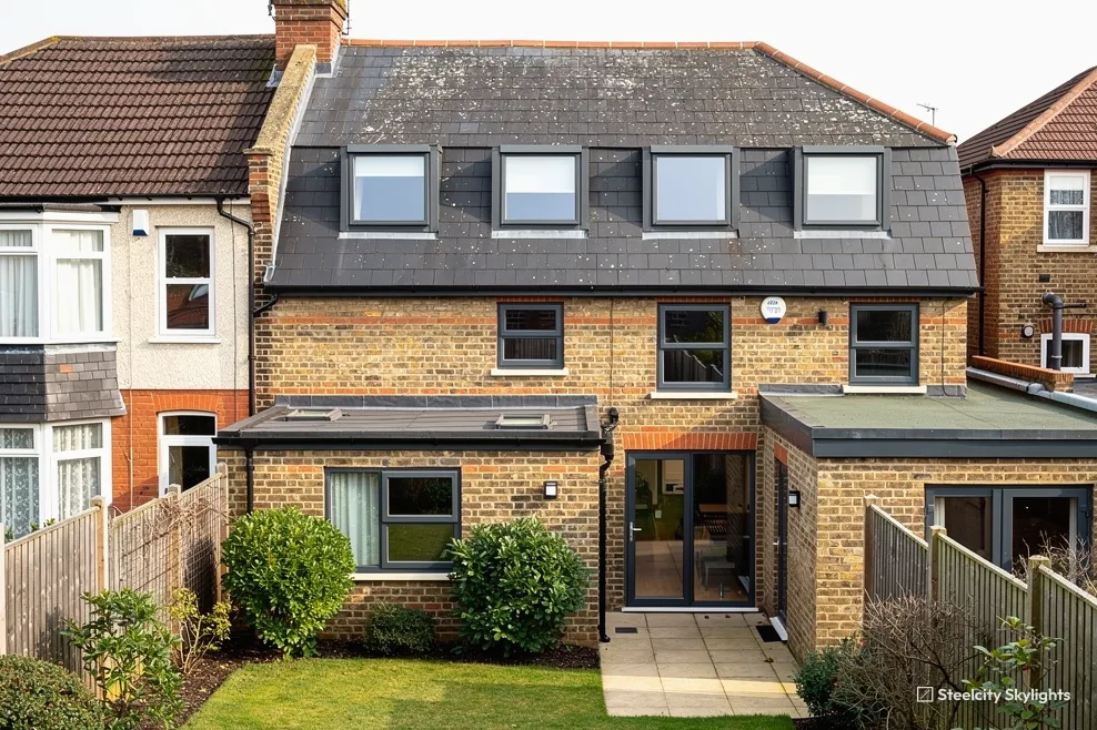 Rear of a yellow brick terrace with a four-window loft conversion and single-storey extensions